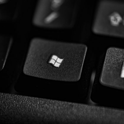 High-quality close-up of a Windows logo key on a black plastic keyboard.